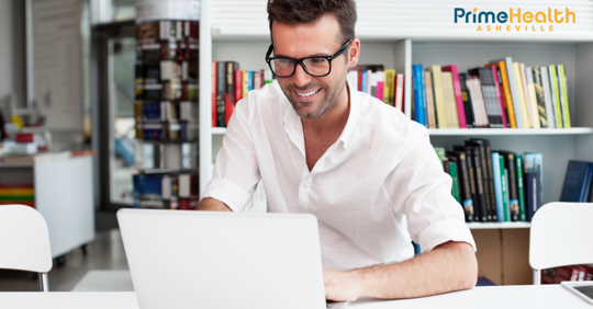 Man smiling at computer